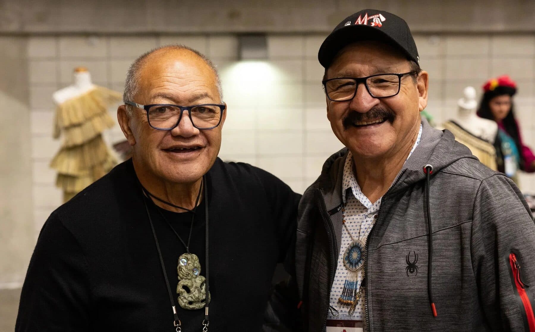 Two kaumātua in kōrero at the World Indigenous Cancer Conference